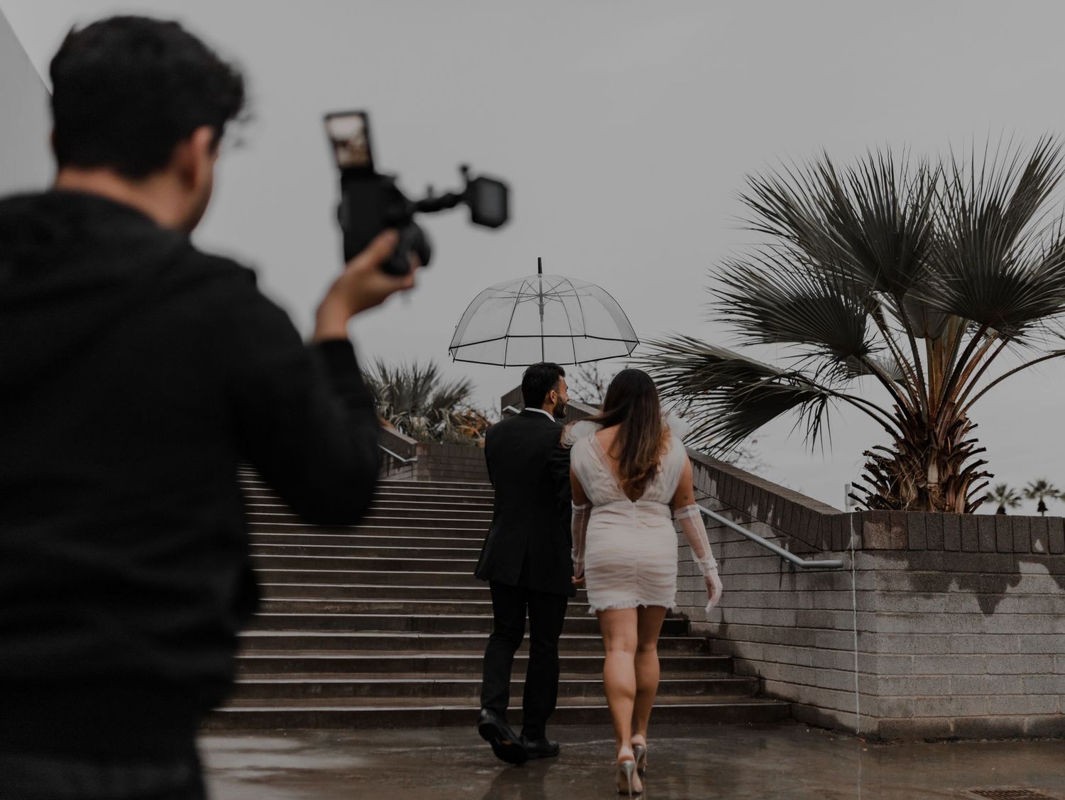 Engaged couple enjoys a playful moment in a portrait session with Sergio Galvan Photography