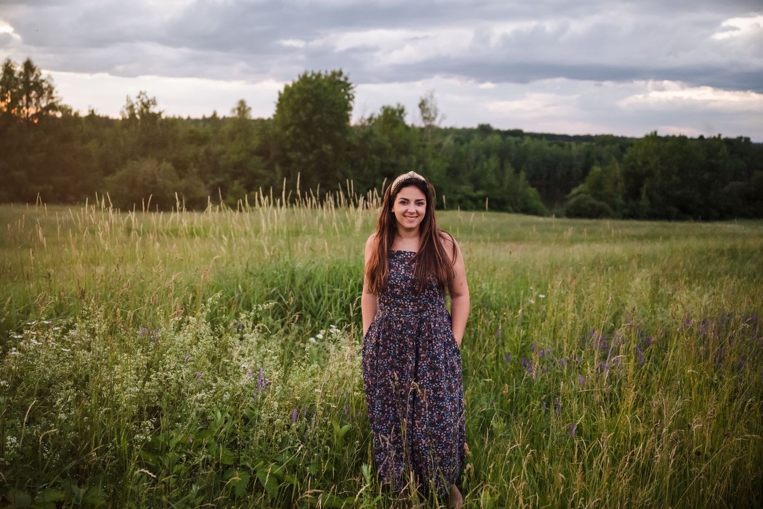 A summer portrait in a wildflower meadow at golden hour.