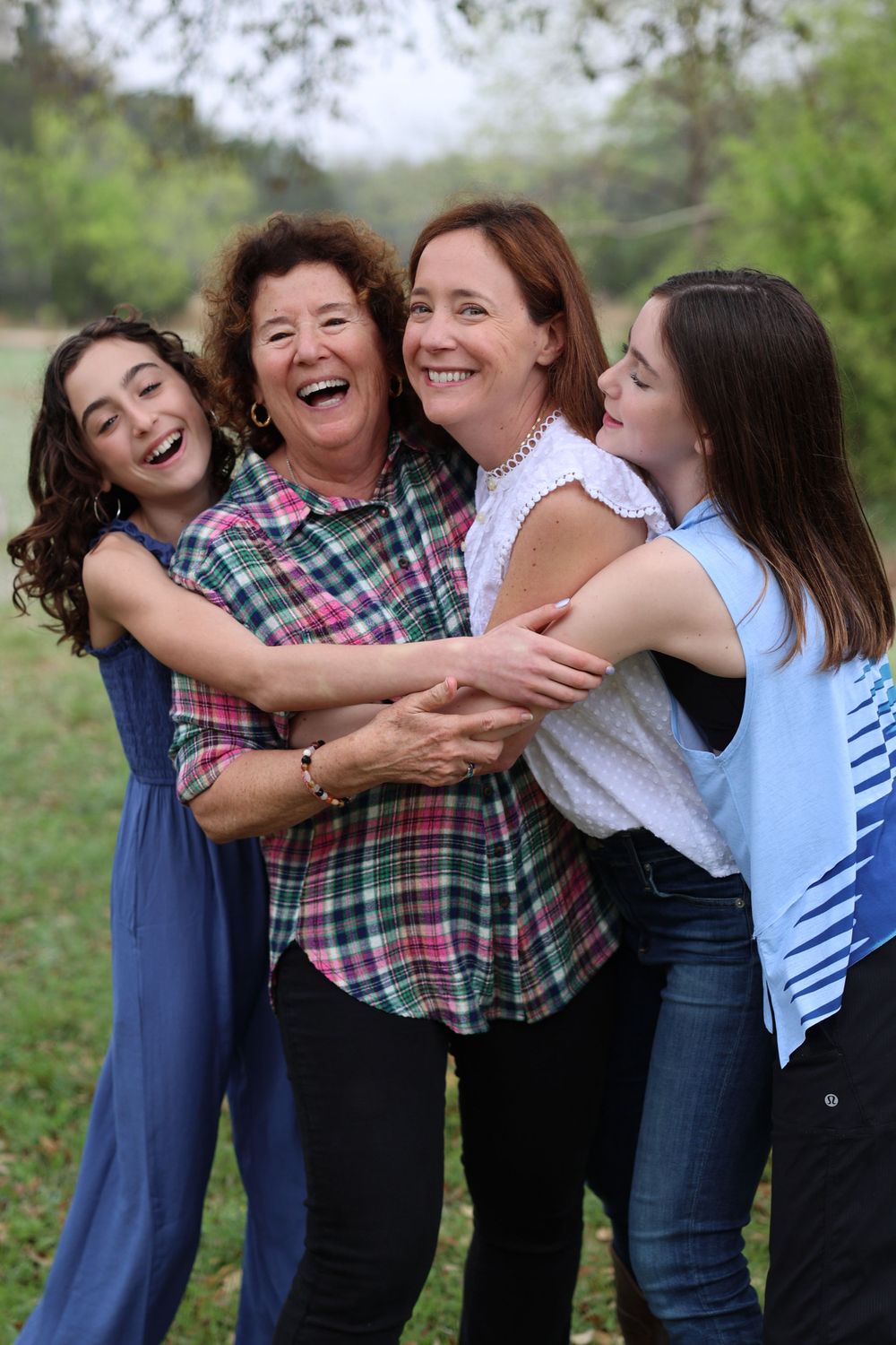 A joyful family moment captured outdoors with natural lighting and genuine laughter.