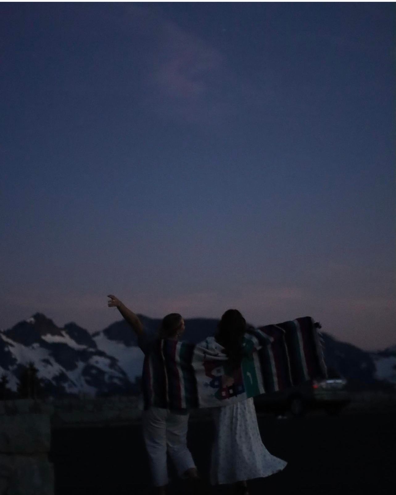 Cora Emilie Media Silhouettes of people against mountain backdrop at dusk.