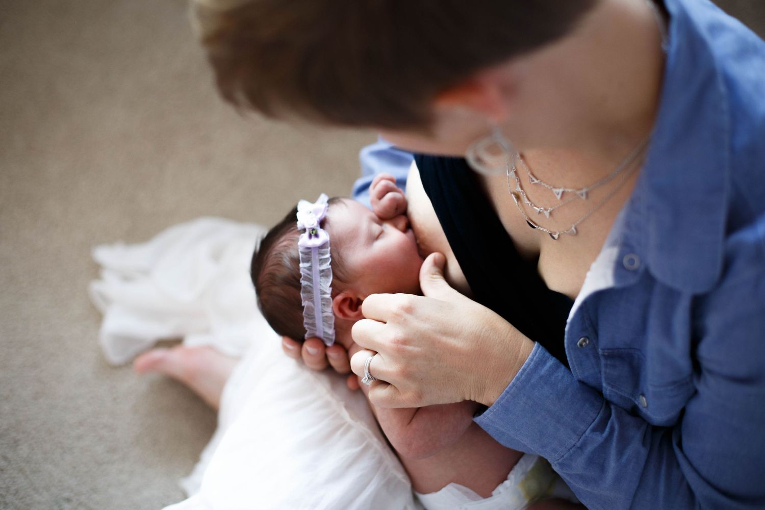 Seattle newborn photographer: A mother breastfeeds her newborn baby at home in Everett