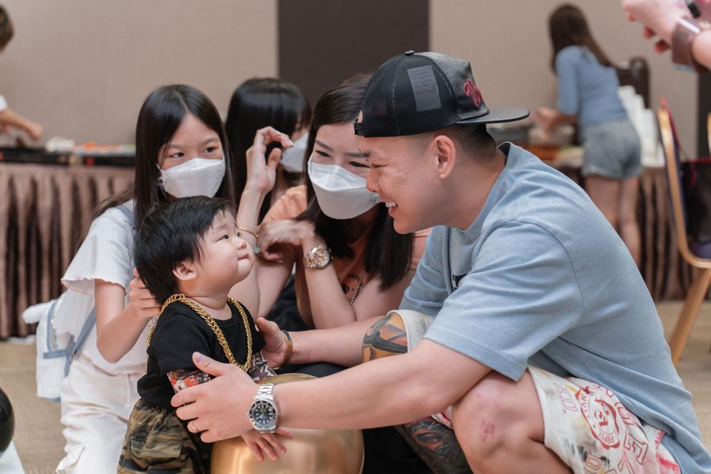 Cheerful indoor gathering with attendees wearing face masks.