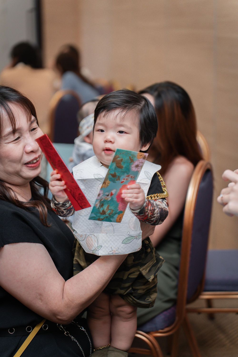 Celebratory moment as special envelopes are shared during a gathering.