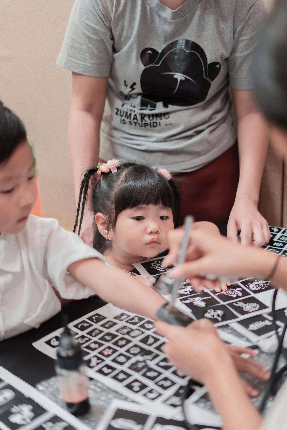 Children participating in an educational activity with a game board on the table.