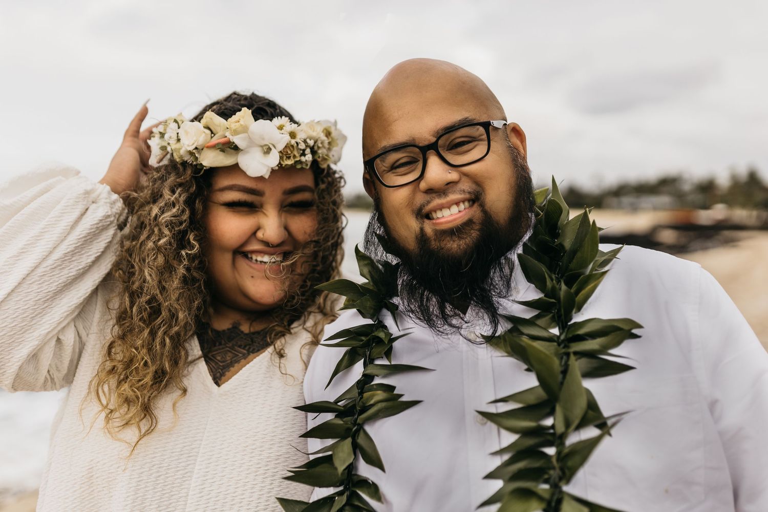 Tropical wedding bride and groom with lush palm trees and sandy beach hawaii