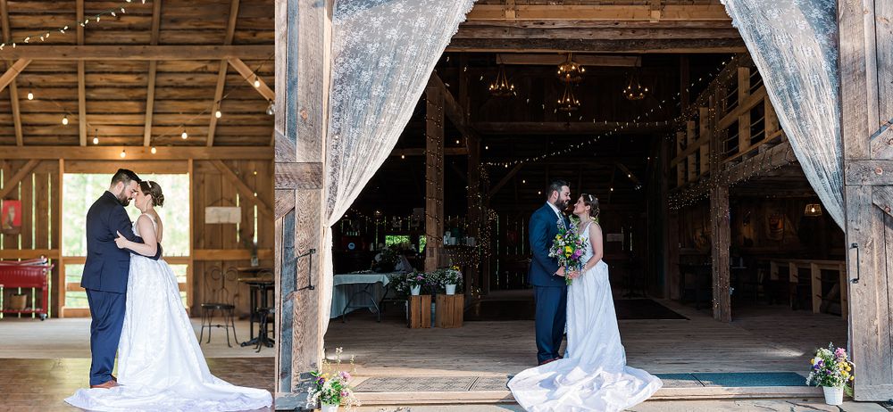 Romantic wedding ceremony moment inside a rustic wooden barn with flowing white drapes.