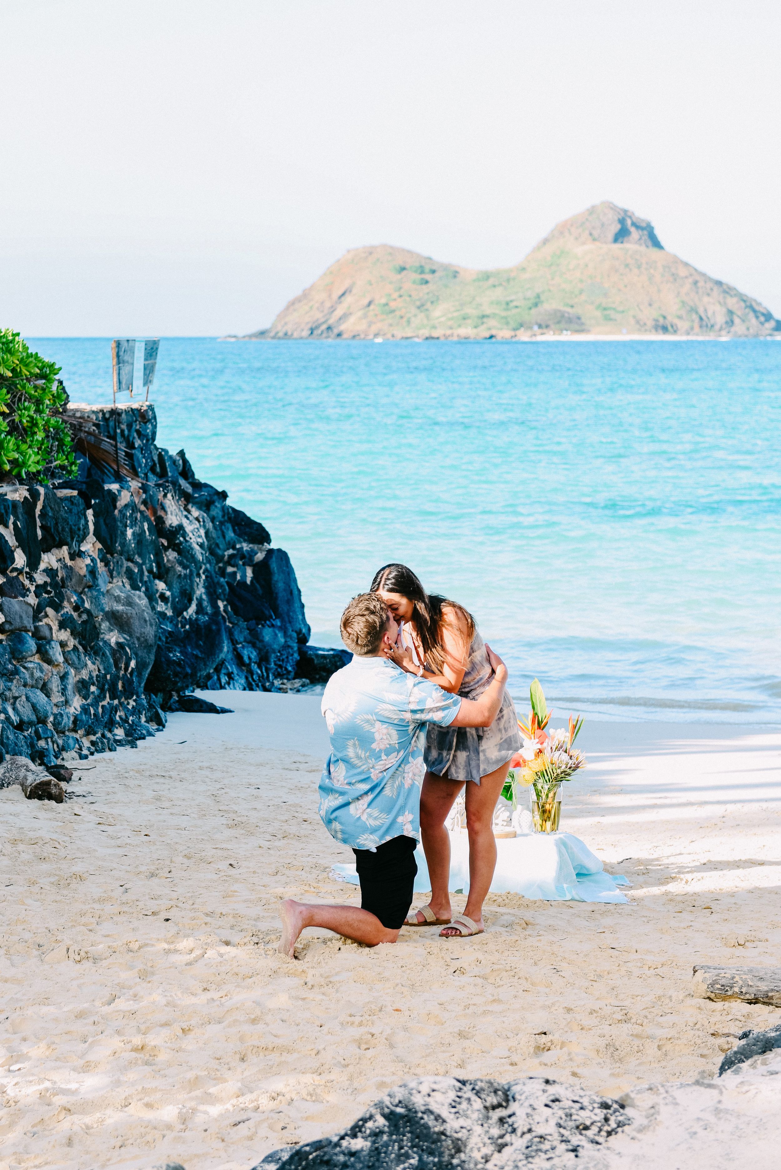 Surprise beach proposal with ocean backdrop in Lanikai, Oahu.