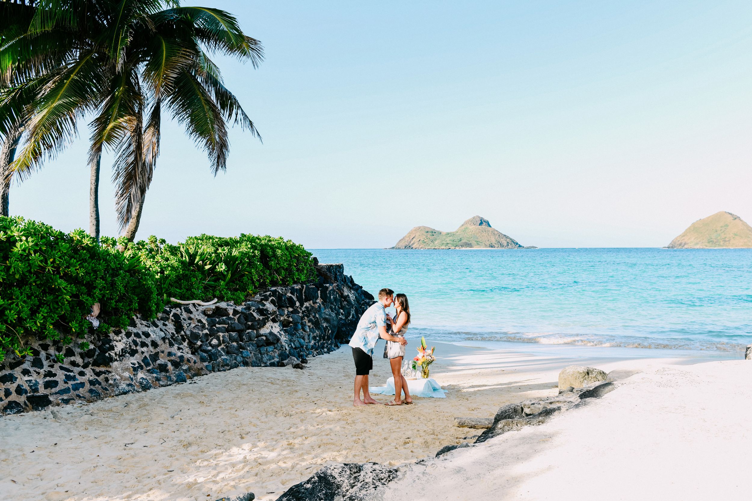 Surprise beach proposal with ocean backdrop in Lanikai, Oahu.