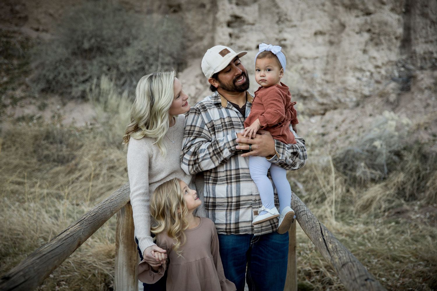 A family shares a happy moment together against a rocky desert backdrop.