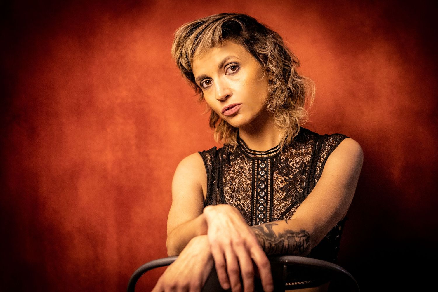 Portrait against orange background with dramatic lighting in vintage style.