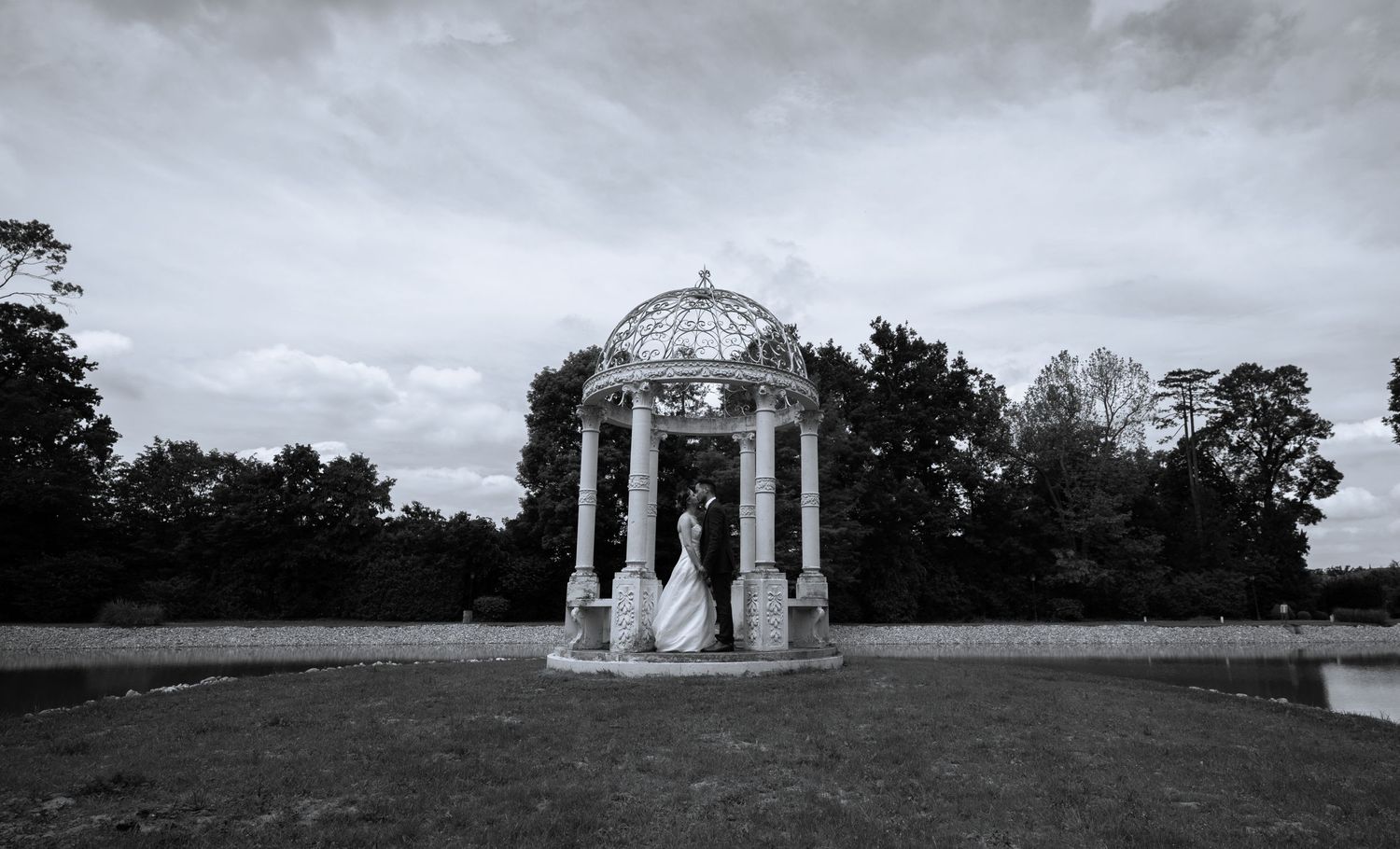 Panoramic landscape view of wedding gazebo and grounds in dramatic black and white.