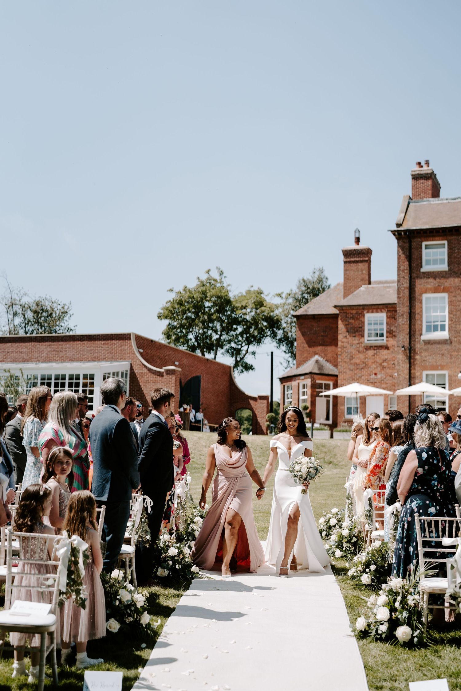bride-coming-down-aisle-stockton-house-outdoor-wedding-ceremony