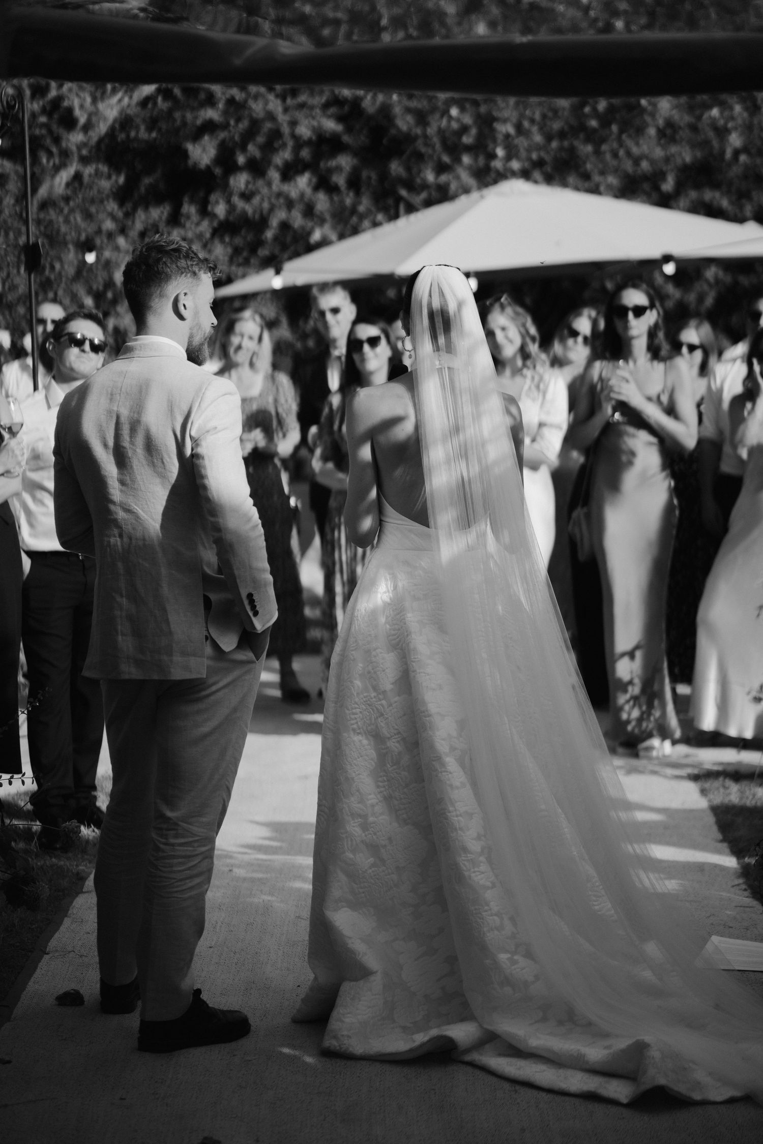 the bride and groom stood in-front of their wedding guests during speeches at their marquee wedding in islip in Oxfordshire