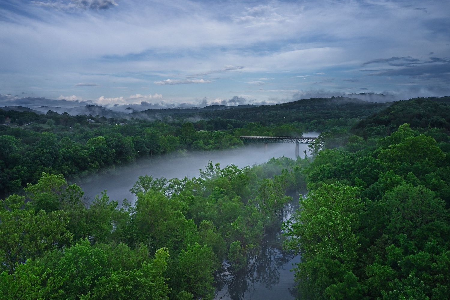 White River Bridge rises out of an early morning fog that covers Clayborn Creek in the Ozark Mountains.