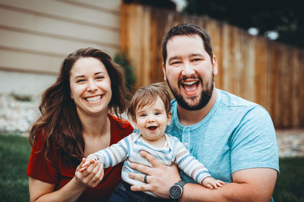 Mother, Father, and young son posing for the professional photographer in Colorado Springs, Colorado.