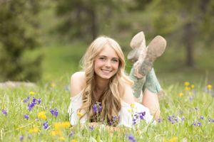 Spring portrait in wildflower meadow with purple lupines and yellow flowers.