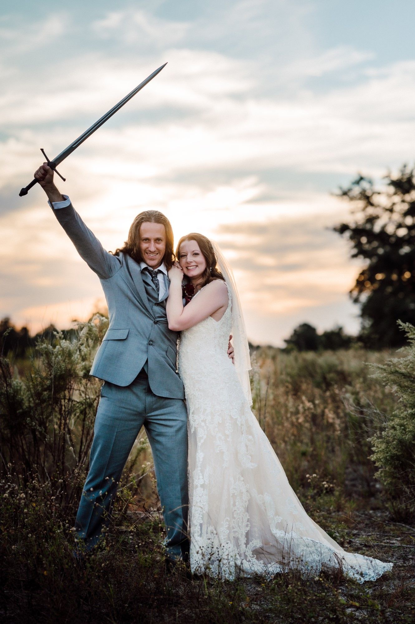 Bride and Groom posing with sword.