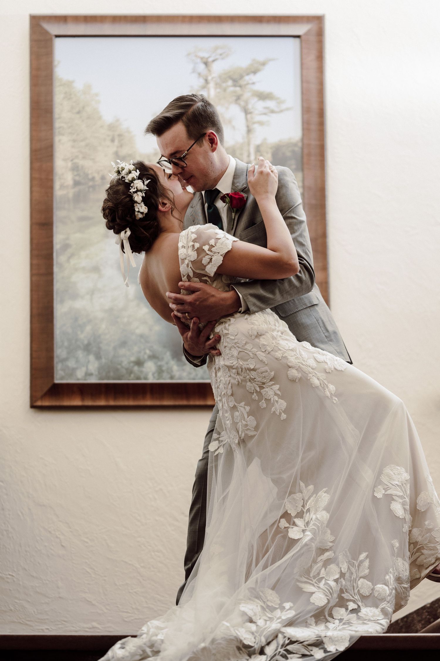 Dip kiss in front of picture frame.