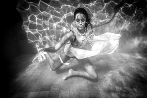 An underwater ballerina in a white skirt