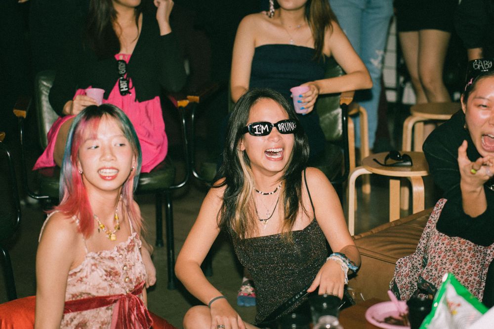 Party guests in festive attire enjoying themselves at a celebration.