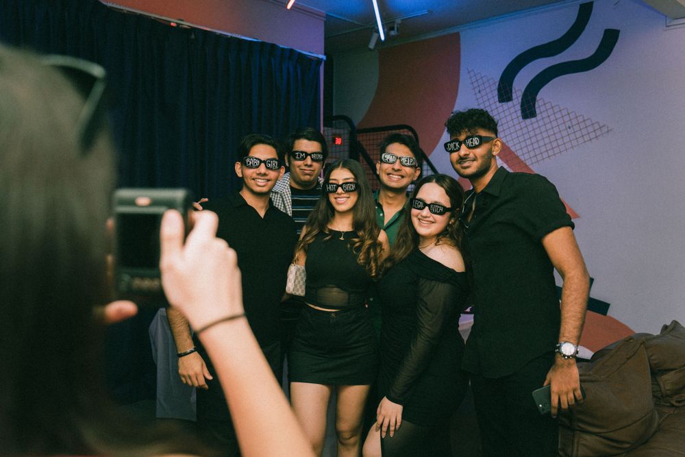 Group photo of friends dressed in black outfits at a party.