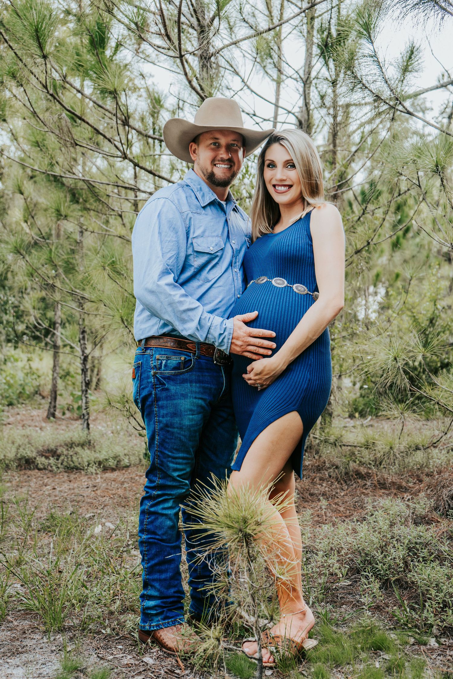 Outdoor Maternity Session at Thatcher Park, Lithia, FL; couple embracing in the long pines