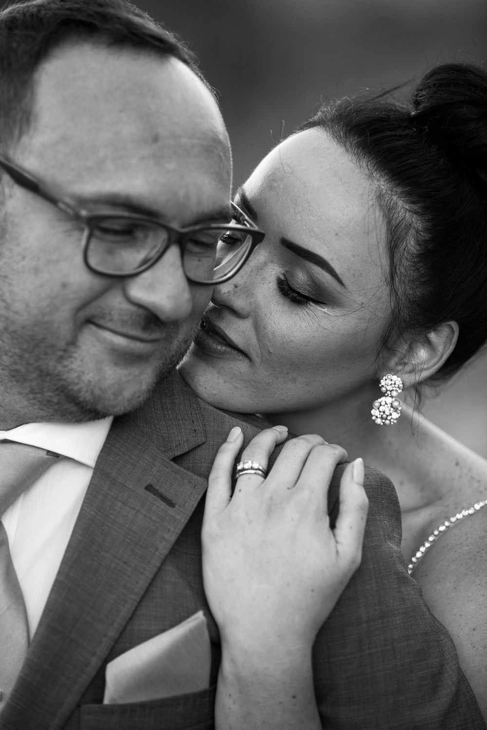 intimate moment while bride kisses her groom on the cheek