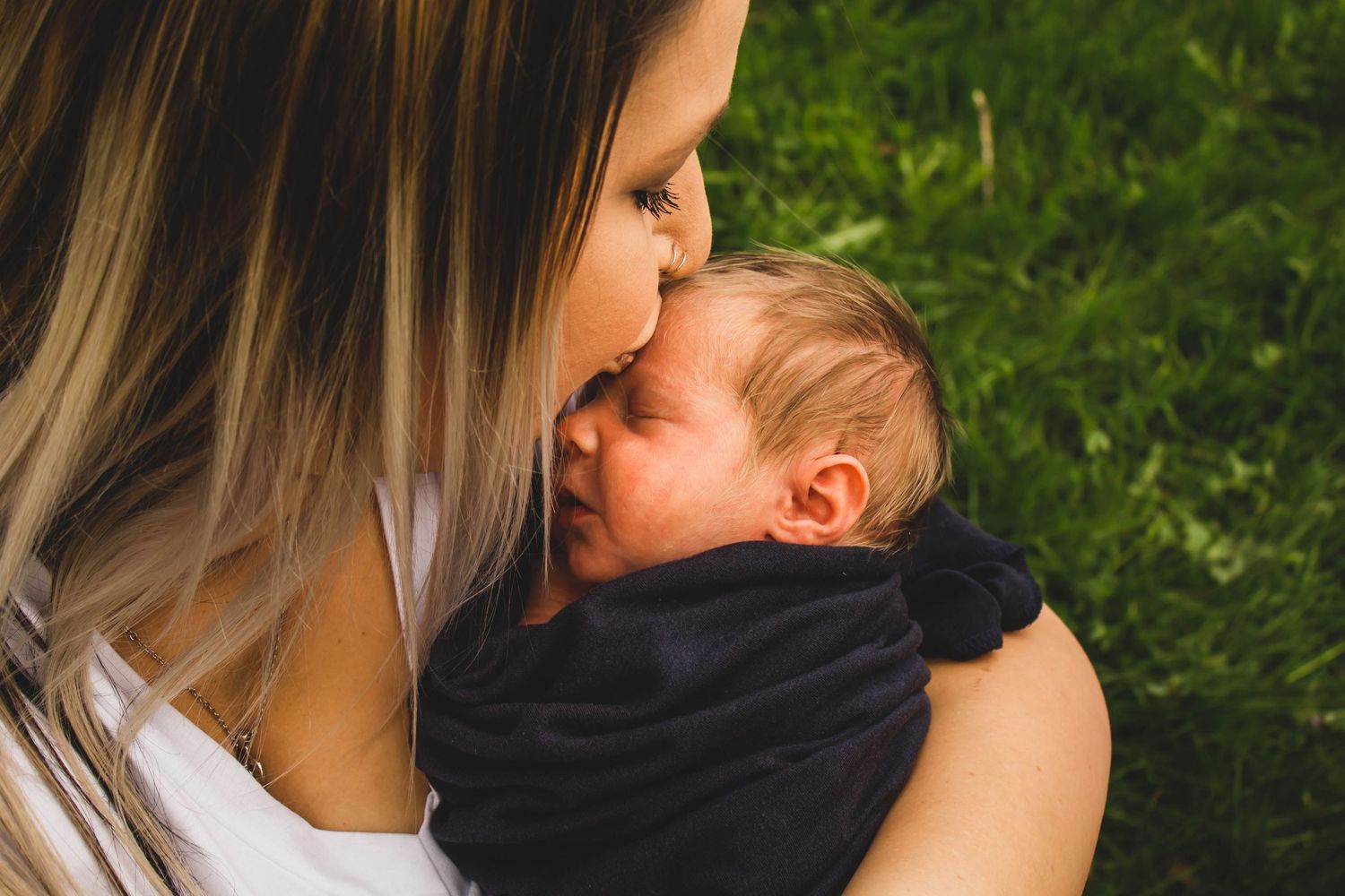 Mother kisses her newborn son | Heart & Hands Birth Services | doula & photography