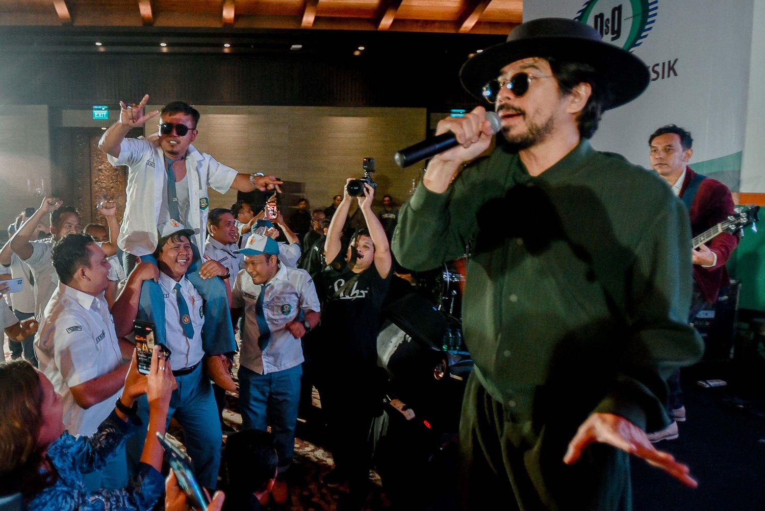 Dynamic concert photo showing performers engaging with excited audience members.