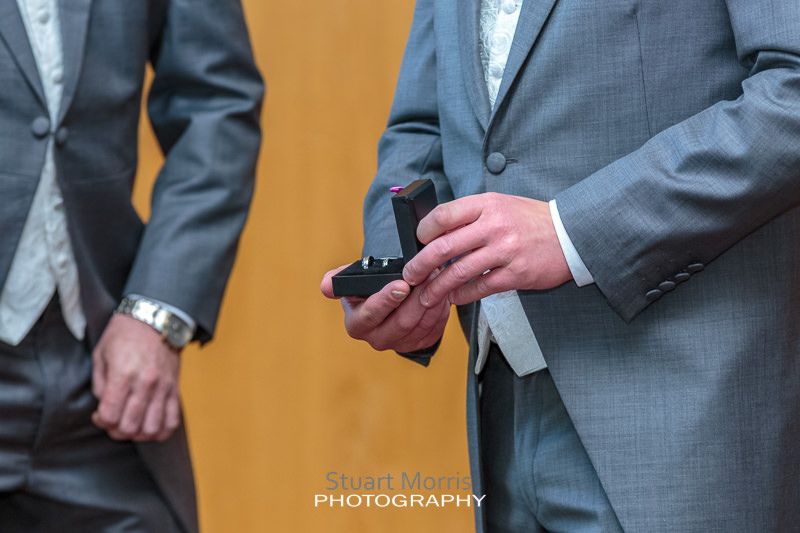 close up of the groom opening the ring box to check they're still there