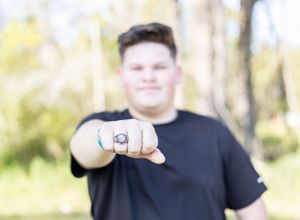 senior boy with ring on hand