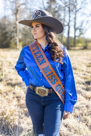 senior cowgirl in field