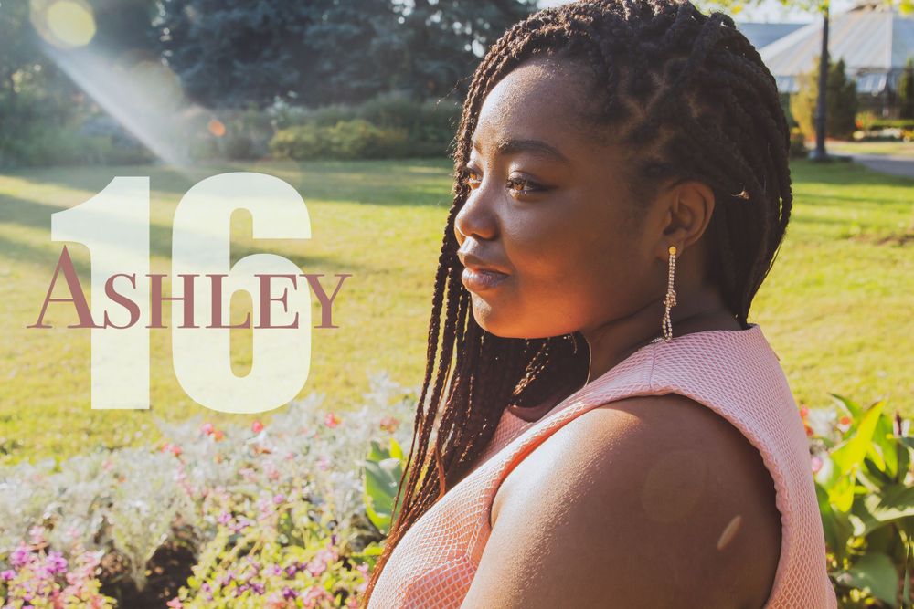 Portrait in golden sunlight with flowers and natural outdoor setting.