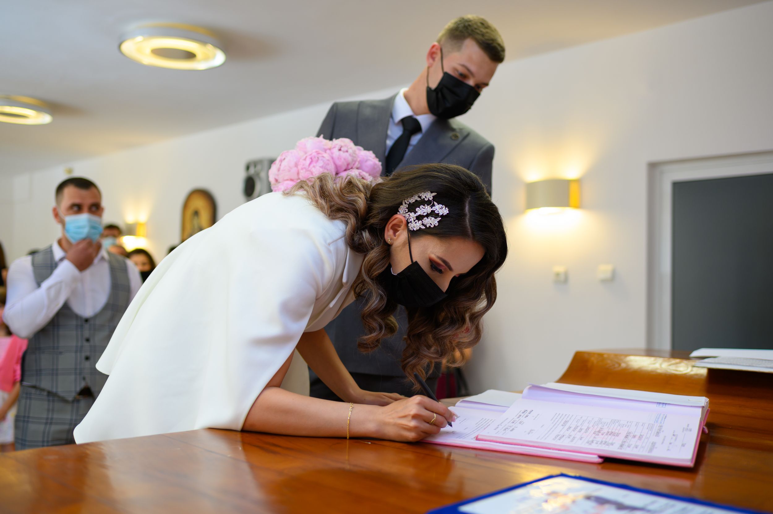 Wedding ceremony proceedings in a bright indoor venue with modern lighting.