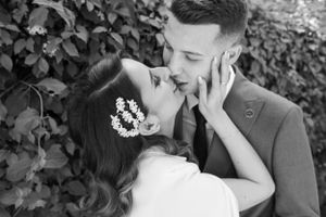 Artistic black and white photo of newlyweds in an intimate pose.