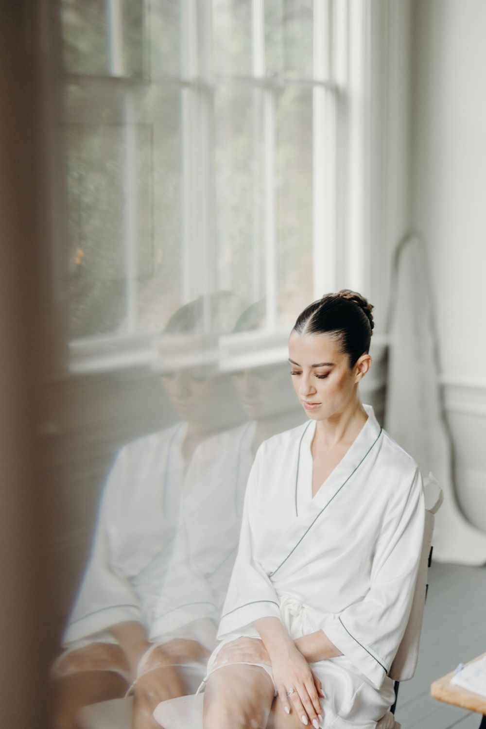 Serene morning preparation scene by window with soft natural light filtering through sheer curtains.