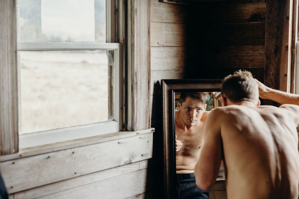 Sunlight streams through windows in a rustic wooden cabin interior.
