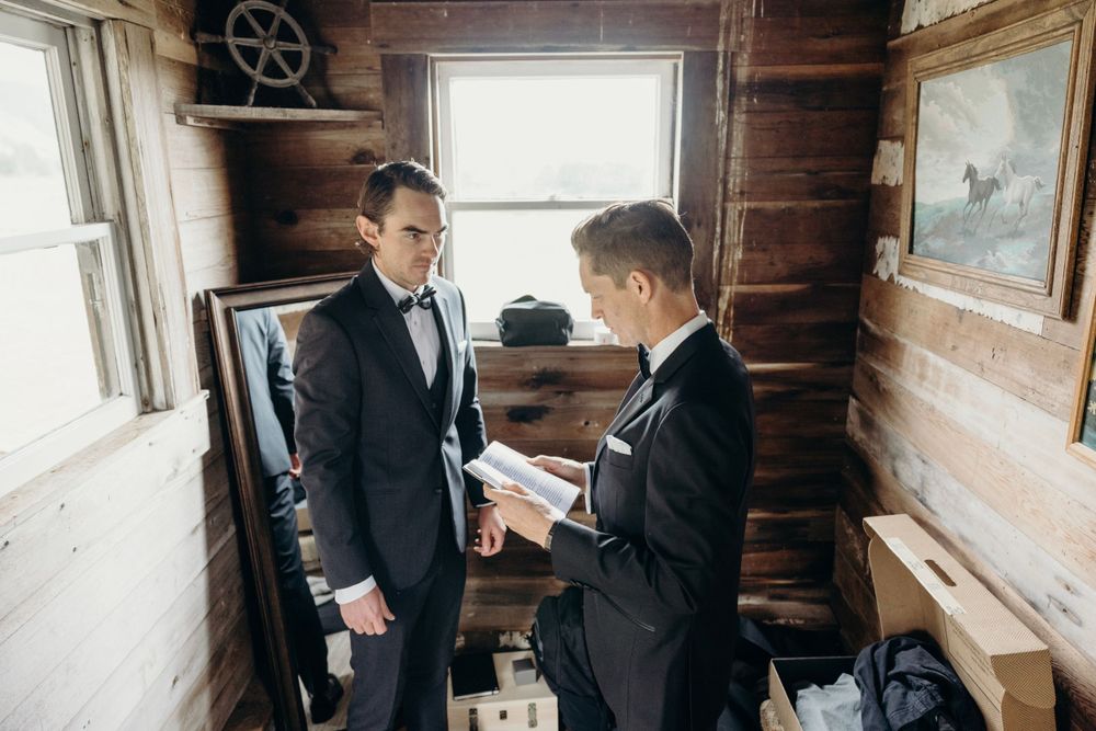 Formal gathering in a rustic cabin interior with natural window lighting.