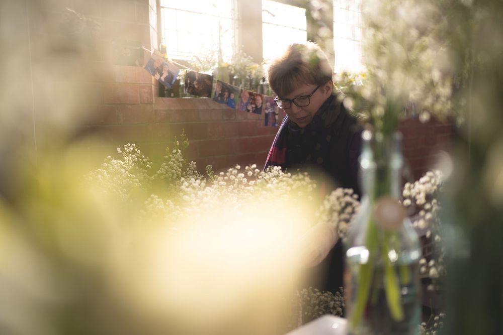 Someone examining items in soft focus with bokeh lighting effects.