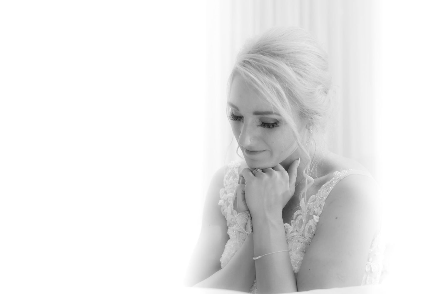 Tender moment of reflection by bride during speeches, black and white photography