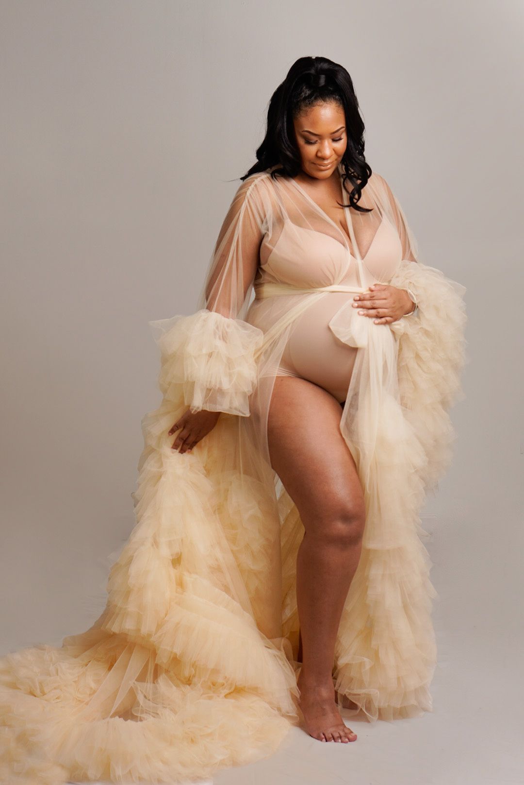 beige maternity dress; woman wearing ruffled maternity dress; dress