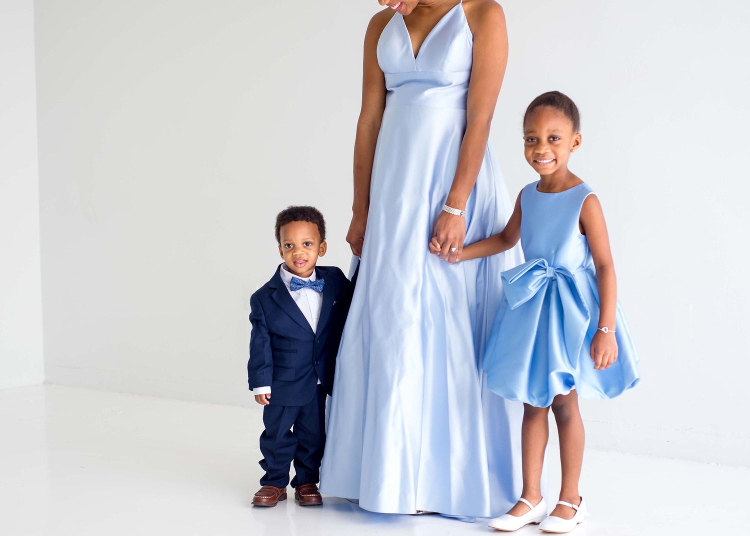 daughter son and mother taking pictures together in a white studio houston texas