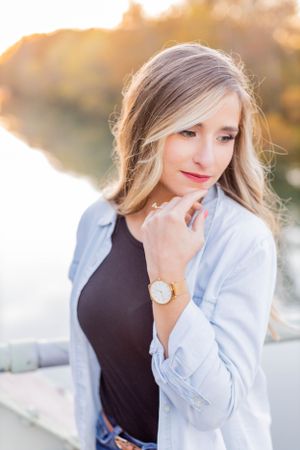 Outdoor portrait of a woman in a light blue blazer and dark top during golden hour sunset in Springfield, MO.
