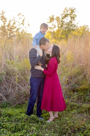 Family sharing an intimate moment together outdoors during golden hour in Springfield, MO.
