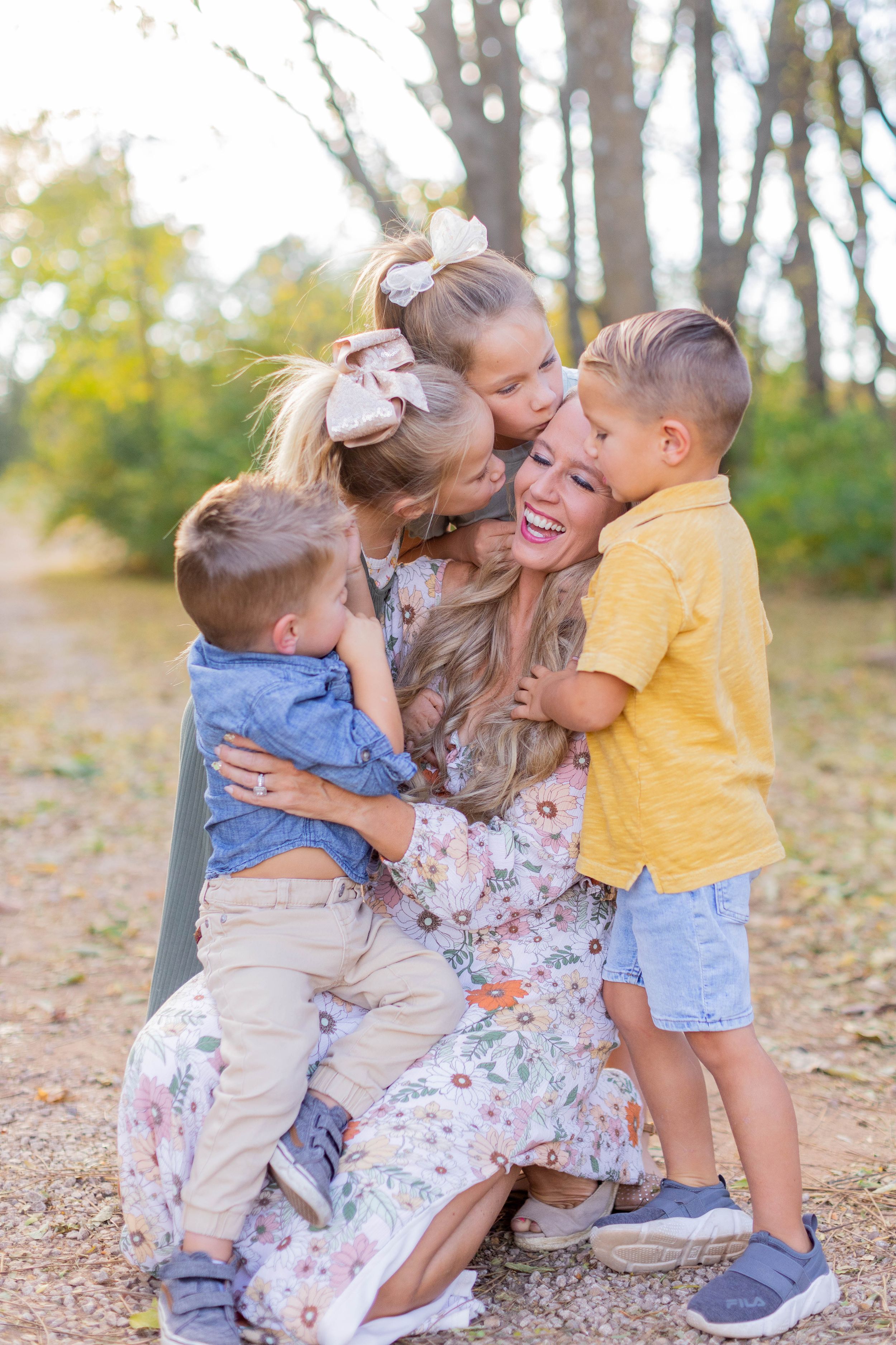 Joyful family moment captured outdoors with embraces and smiles in Springfeild, MO.