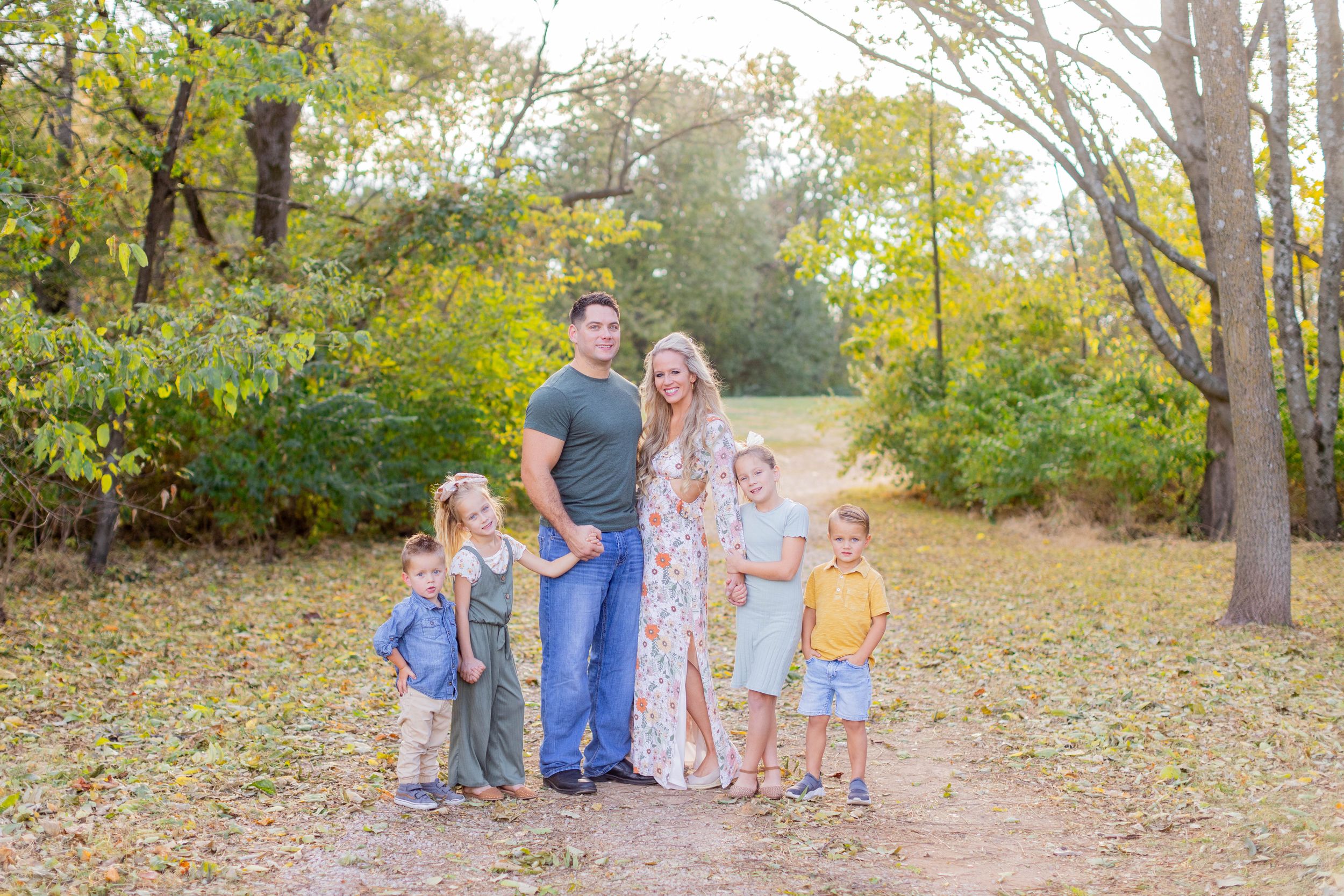 Family of six poses together on nature trail during autumn season in Springfield, MO.