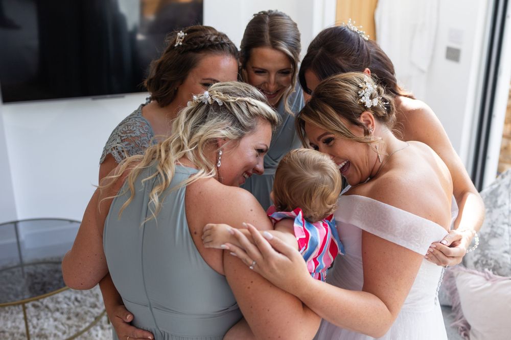 Bride with bridesmaids hugging