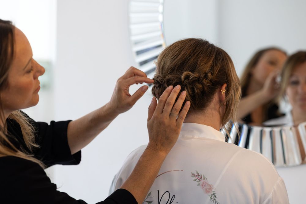 Bride getting her hair and makeup done on wedding day