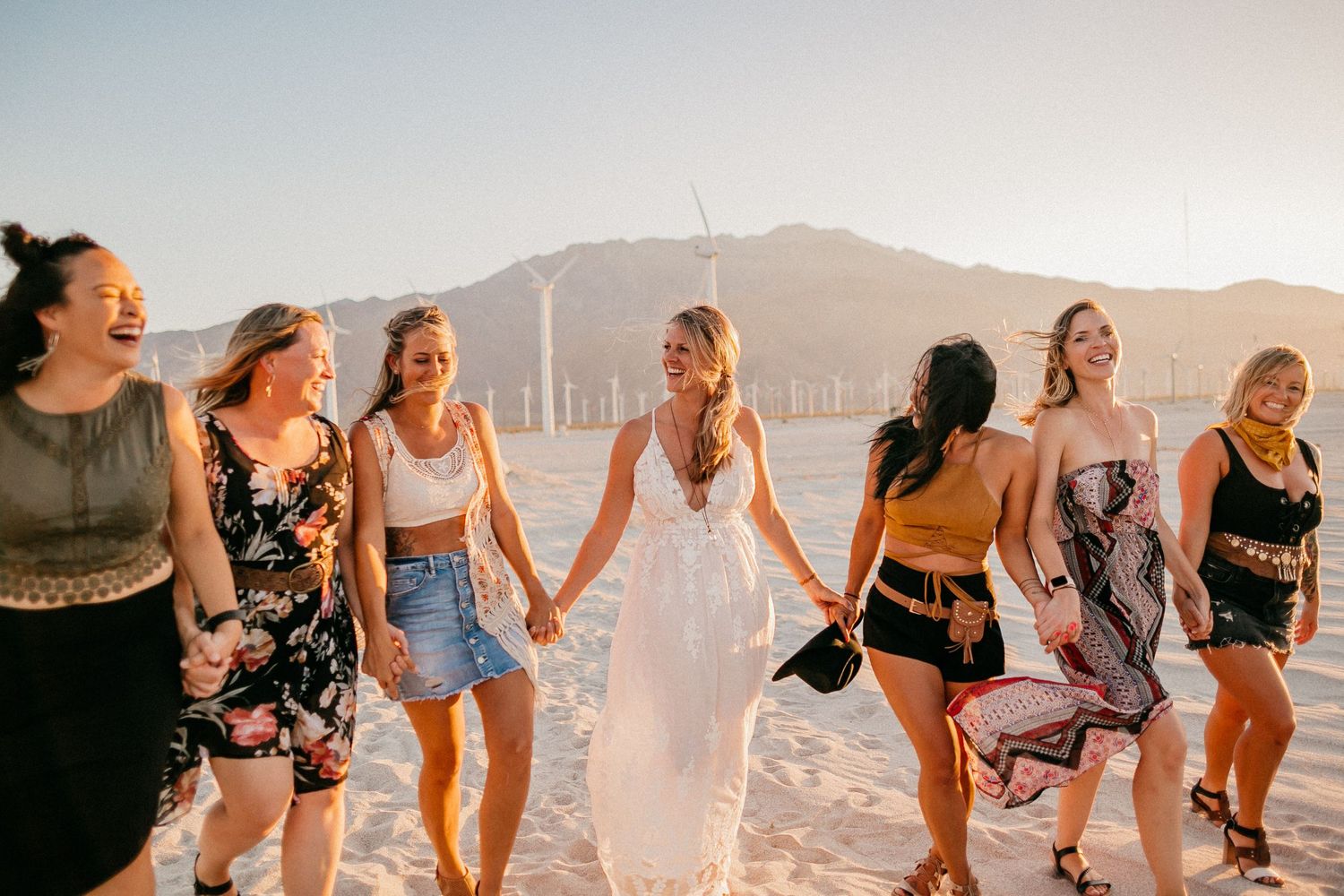 Group of friends walking together against a mountainous sunset backdrop.
