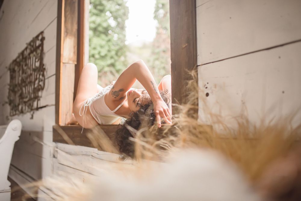 Dreamy window light illuminates a vintage-style indoor photo shoot.